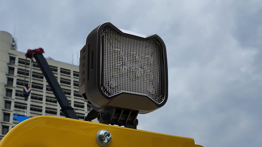 TYRI BASEline S2 LED work light mounted on the roof of a yellow industrial vehicle, providing durable illumination for construction and off-highway operations.