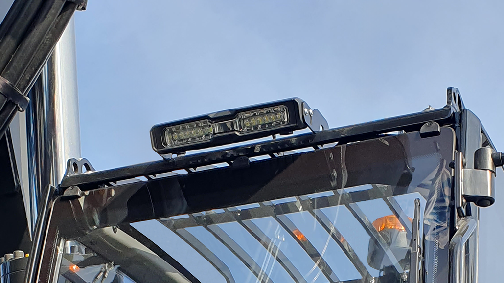 TYRI V12 LED work light mounted on a construction vehicle roof, providing powerful illumination for demanding worksite operations.